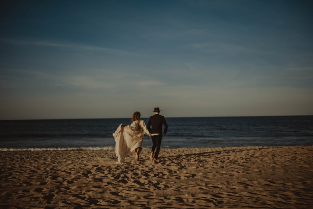 Couple-running-bride-groom-beach-ocean-beach-elopement-nags-head-outerbanks-northcarolina.jpg