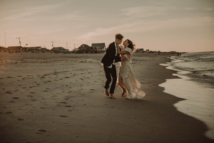 bride-groom-running-kissing-Cute-beach-elopement-photography-nags-head-northcarolina-Carolina.jpg