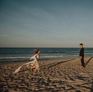bride-groom-running-ocean-beach-elopement-northcarolina.jpg