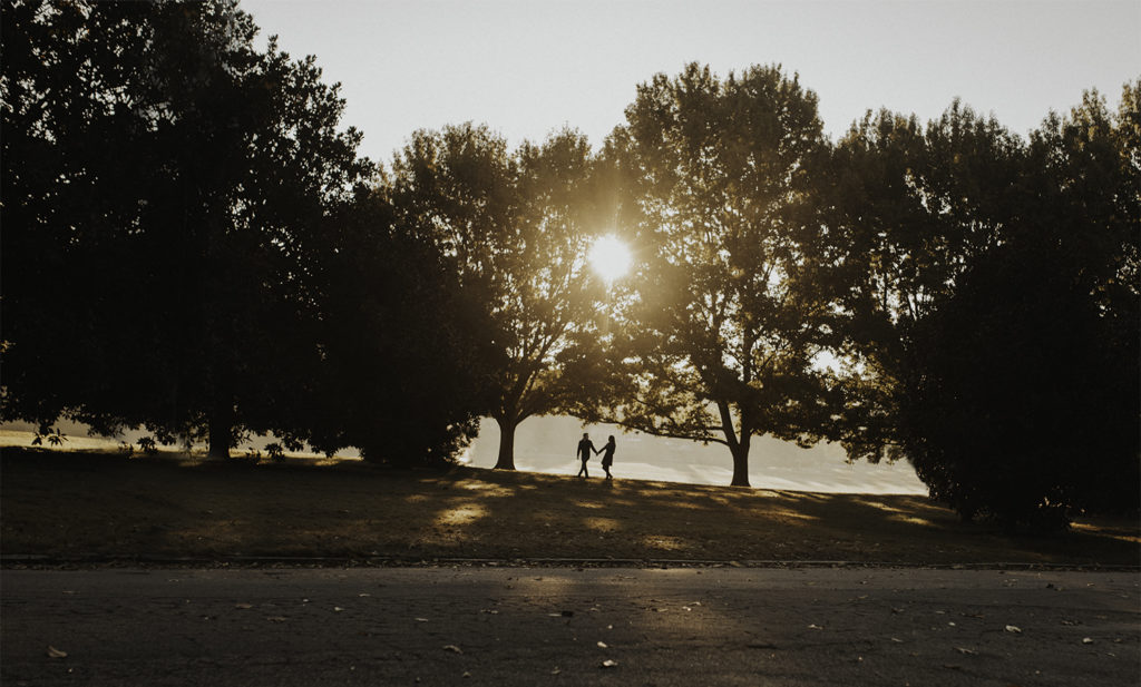Silhouette of a couple walking at sunrise in Piedmont park Atlanta