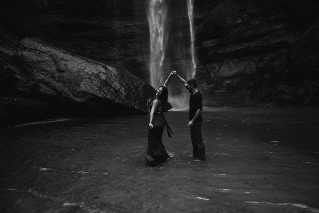 black and white photo of the guy twirling the girl taken under the waterfall taken at Toccoa falls in Georgia 