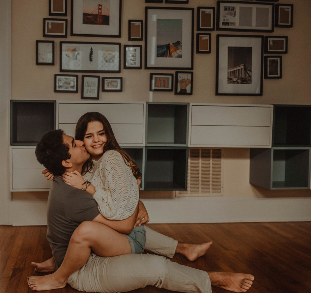 photo of the couple sitting on the floor and hugging taken at an airbnb in atlanta
