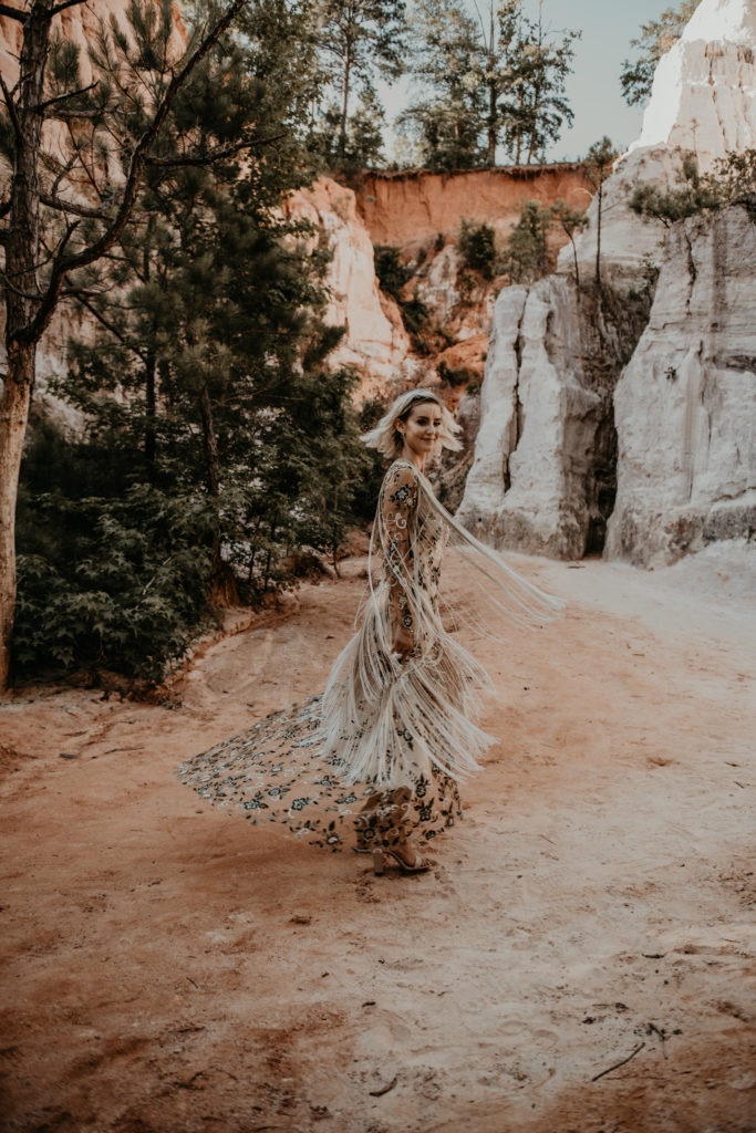 Bride twirling her dress with tassels during their elopement photos at Providence canyon