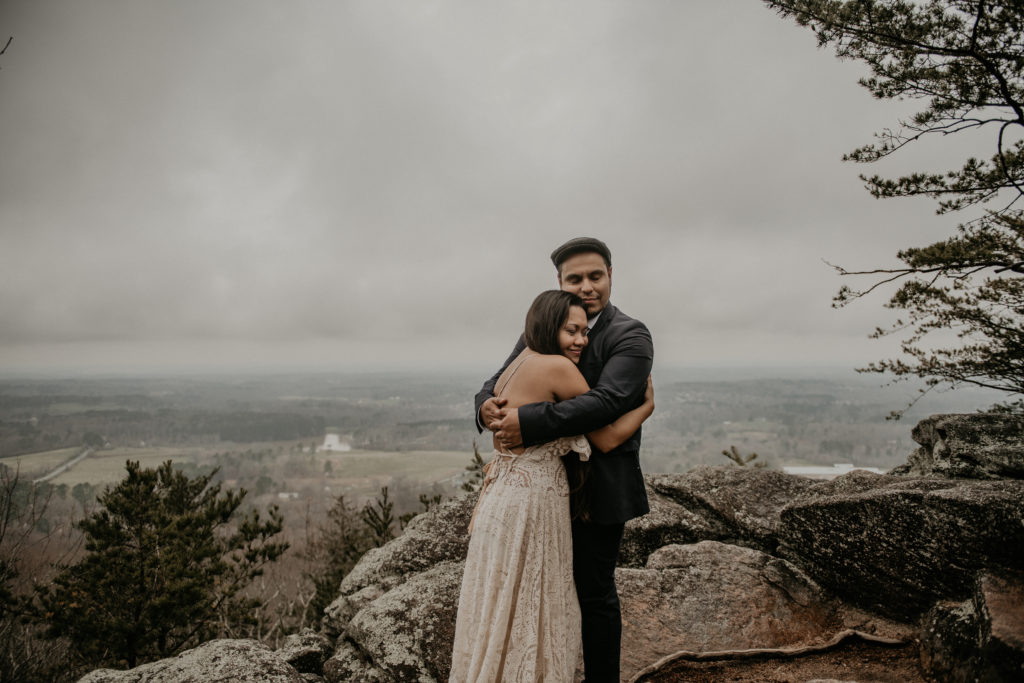 Photo of the couple hugging taken at Sawnee mountain in Georgia 