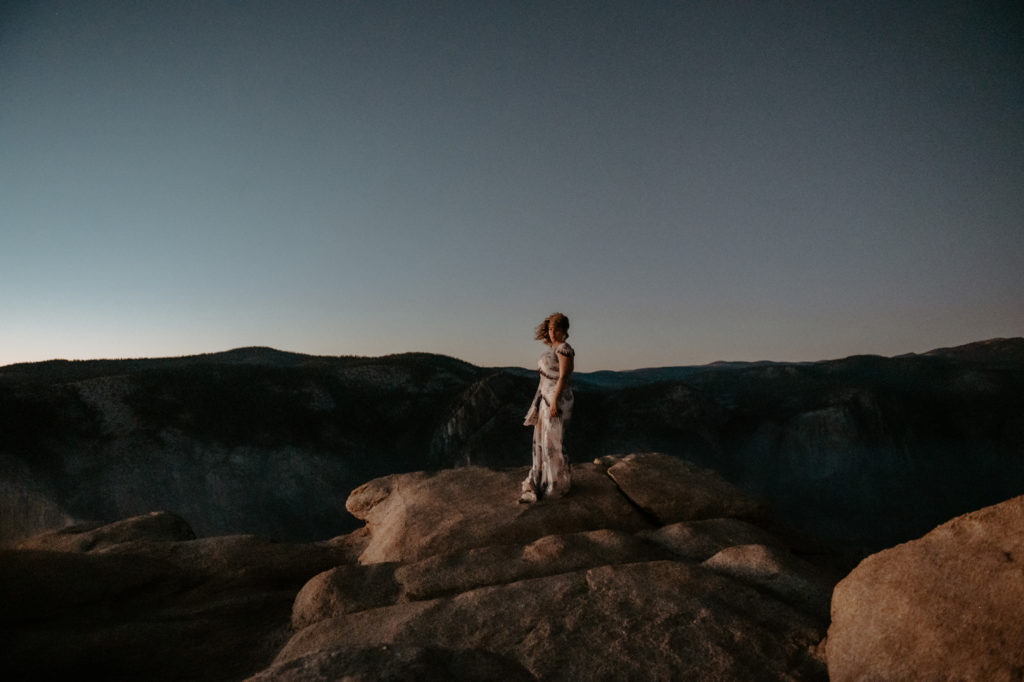 photo of the bride standing on top of a rock taken at yosemite national park