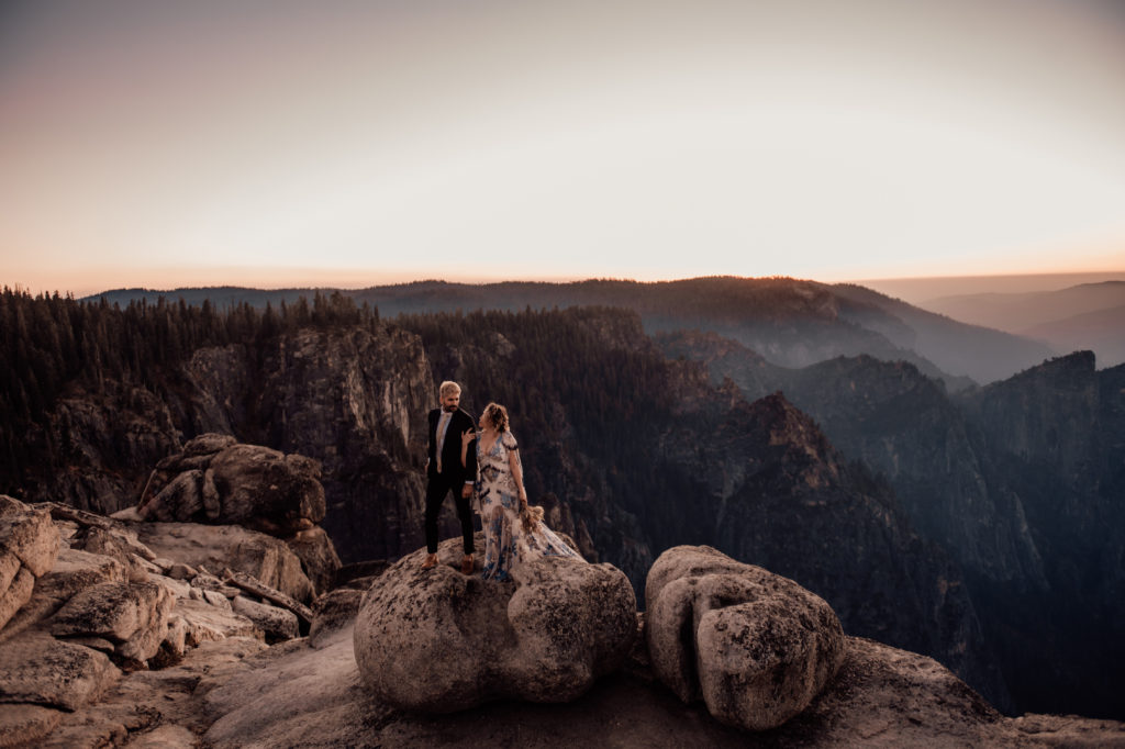 bride and groom holding hands and looking at each other taken at yosemite national park during sunset