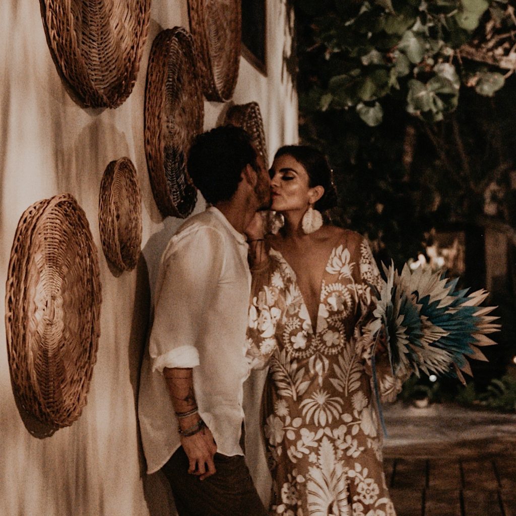 Night photo of the bride and groom kissing taken at an elopement in Tulum Mexico