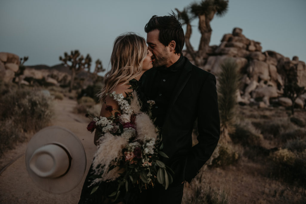 Bride and groom kissing taken at a Joshua tree elopement