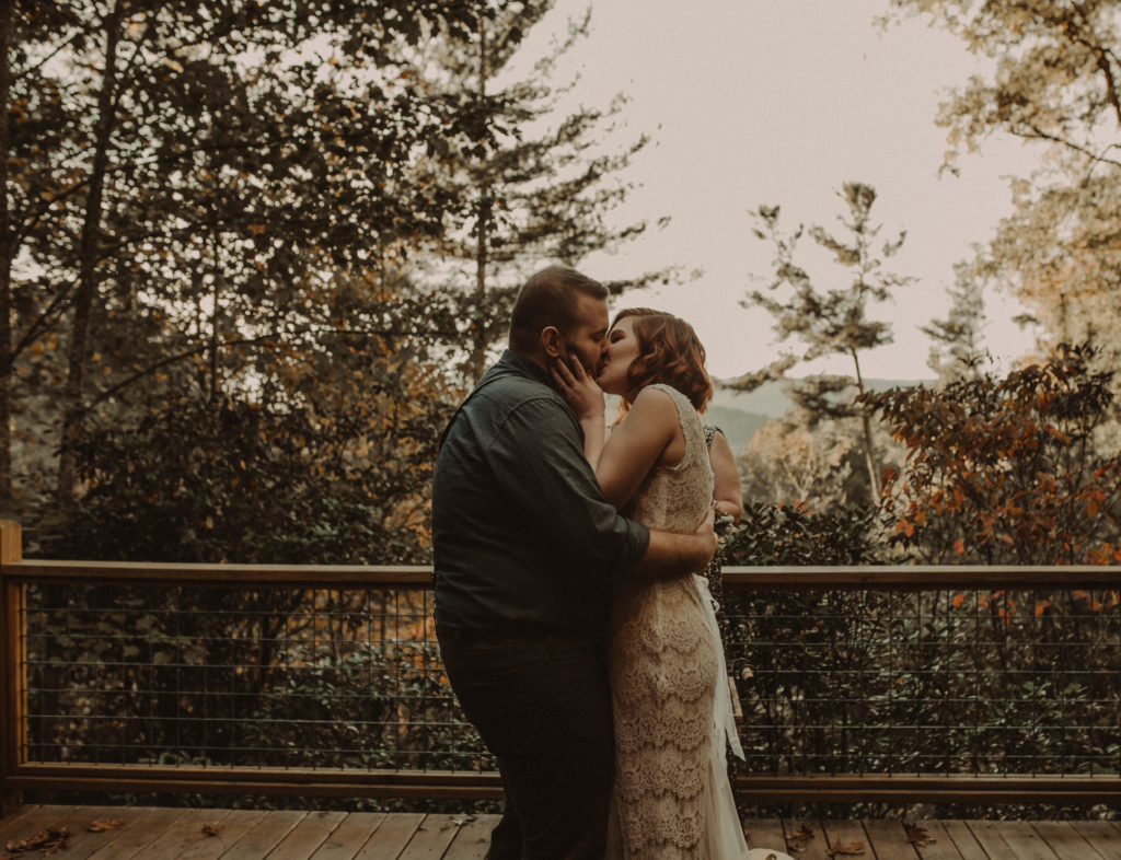 bride and groom sharing their first kiss taken at a cabin airbnb elopement in north georgia 