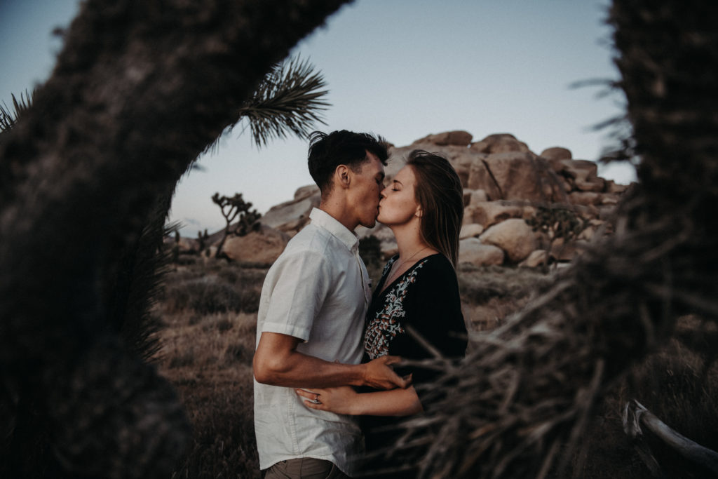 photo of the Couple kissing taken during an engagement session at Joshua tree national park