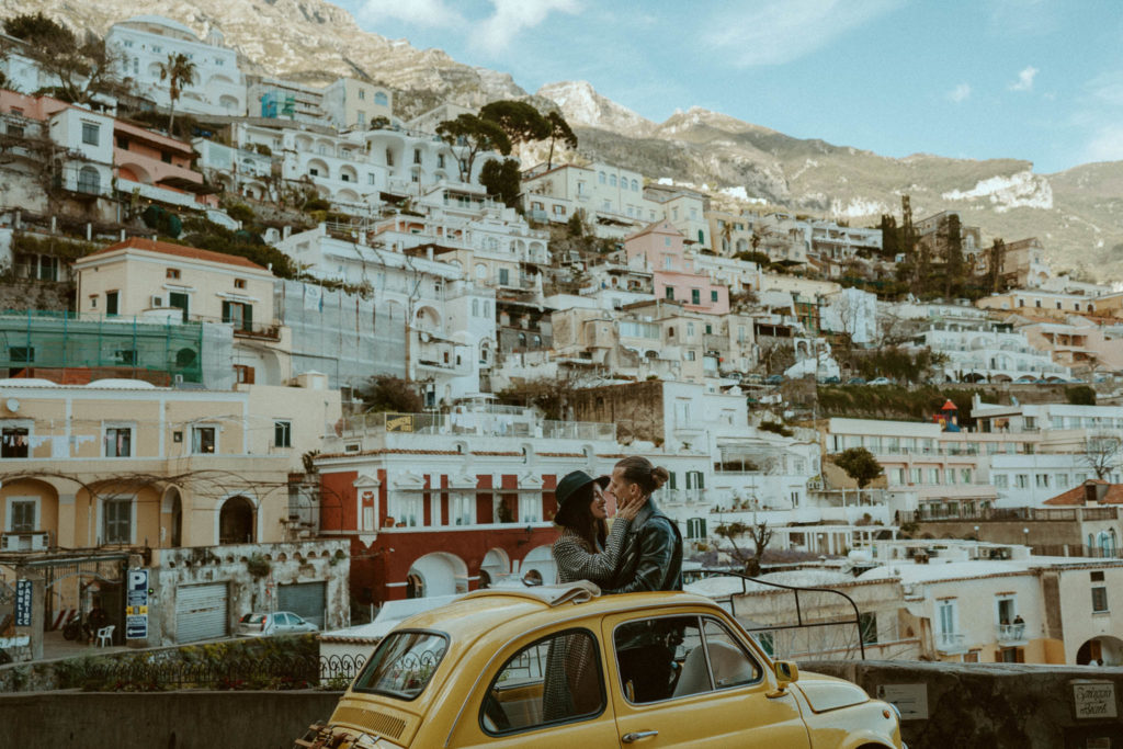 Couple standing inside a vintage fiat taken in Positano 