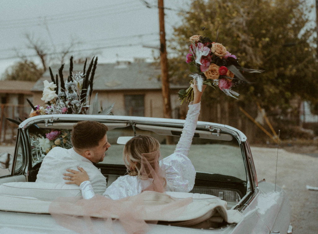 photo of the couple driving away in their vintage car after their las vegas elopement