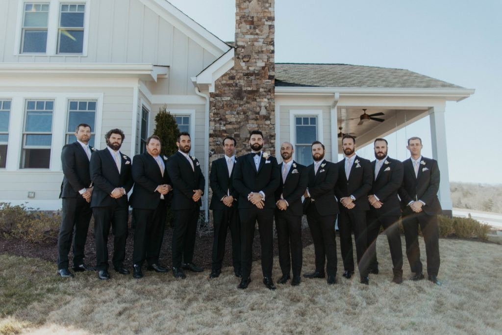photo of groomsmen on the side of the cottage at Kaya Vineyards & Winery, a premium Georgia wedding venue