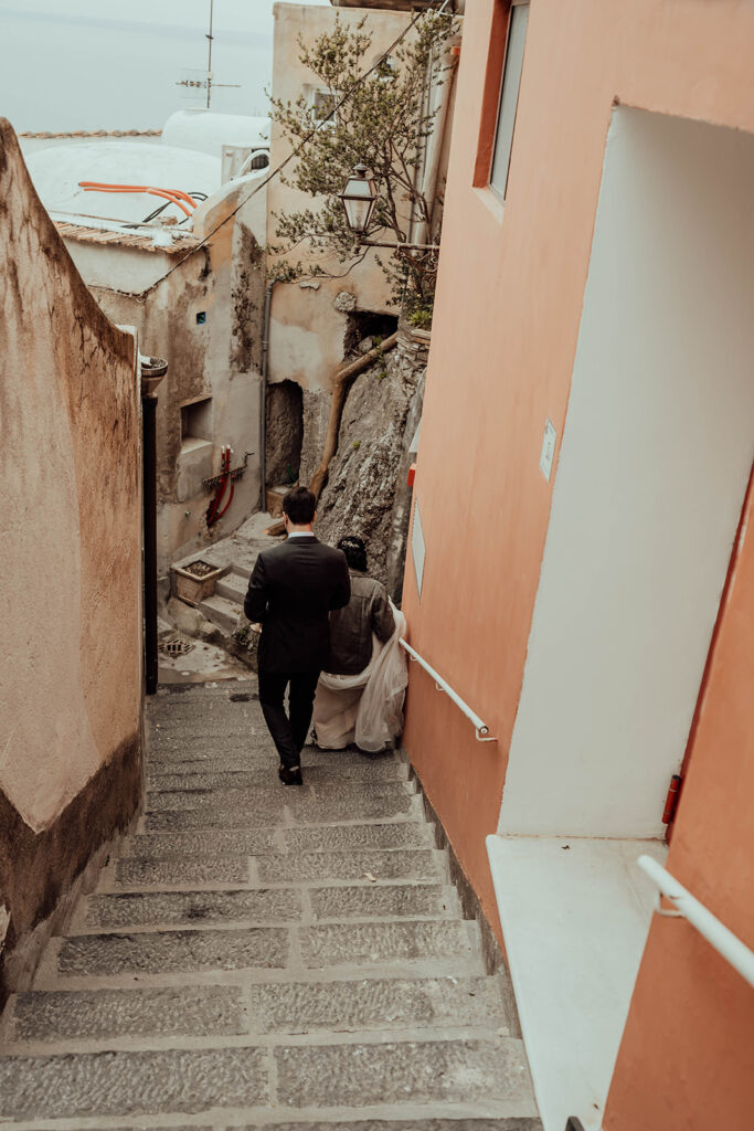 Bride and groom walking in Positano 