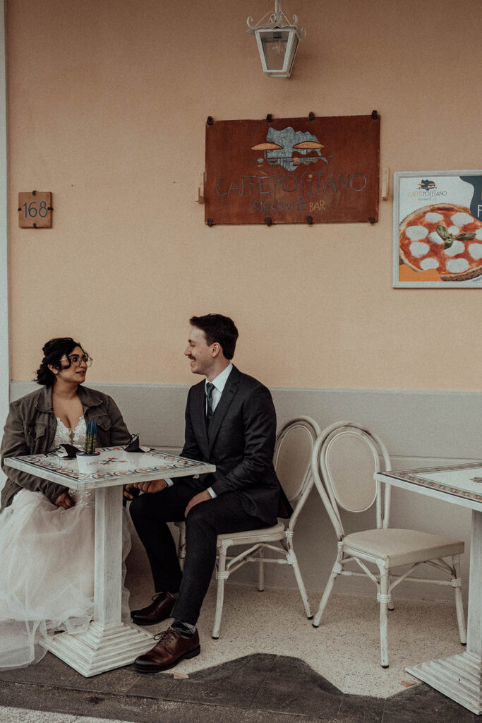 Bride and groom having coffee at Café Positano