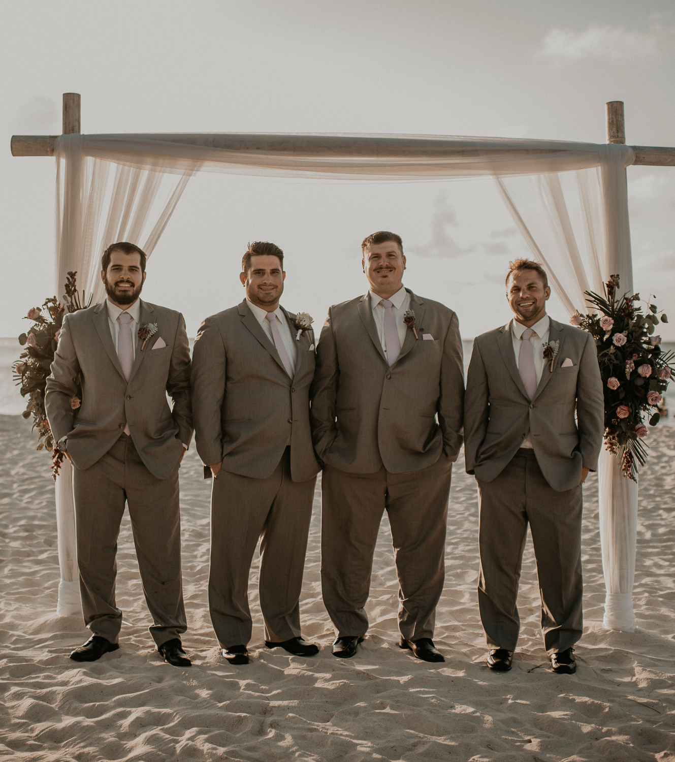 Groom and groomsmen photos on the beach from a destination Aruba Elopement wedding at Riu Palace