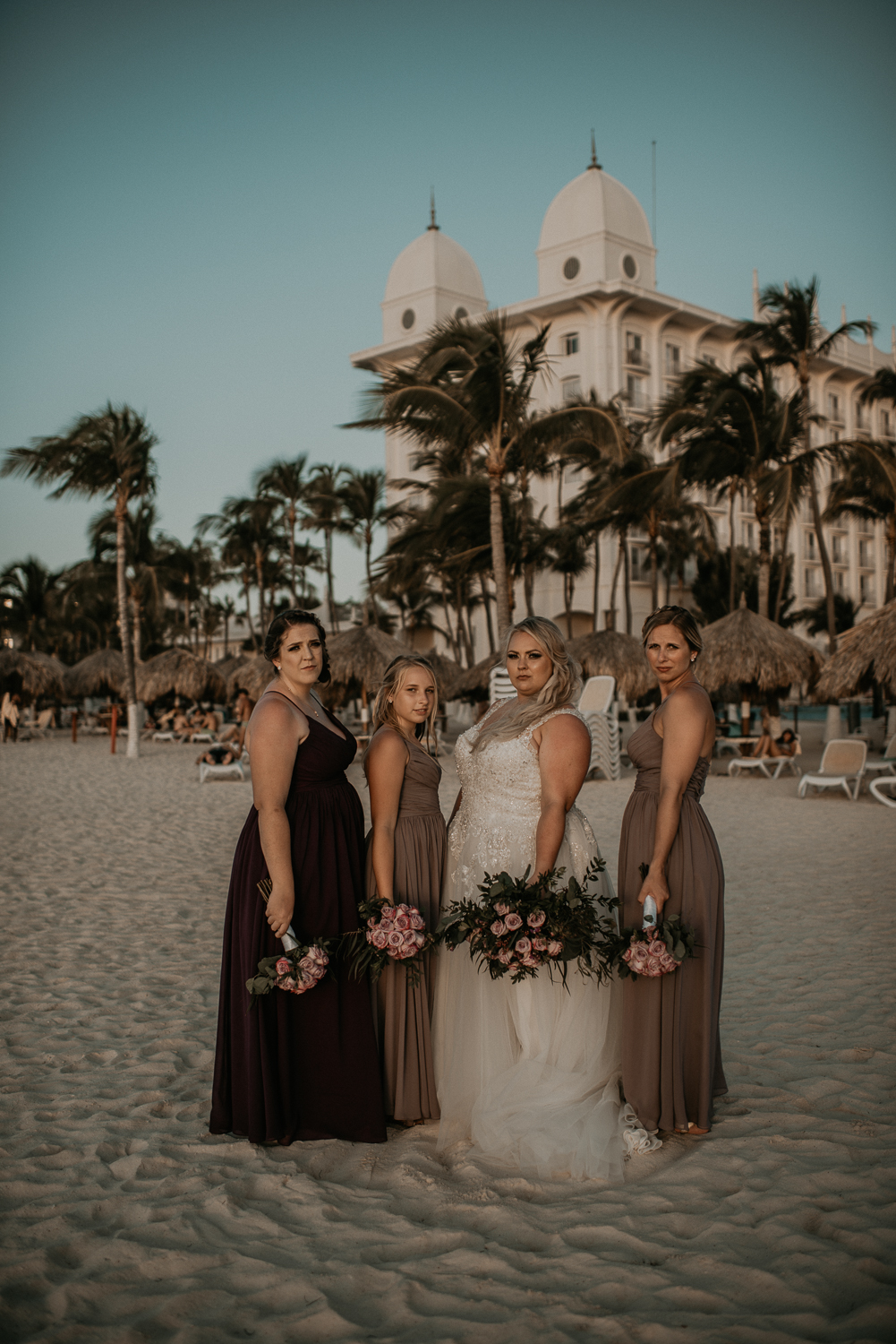 Bride and bridesmaids photos on the beach from a destination Aruba Elopement wedding at Riu Palace