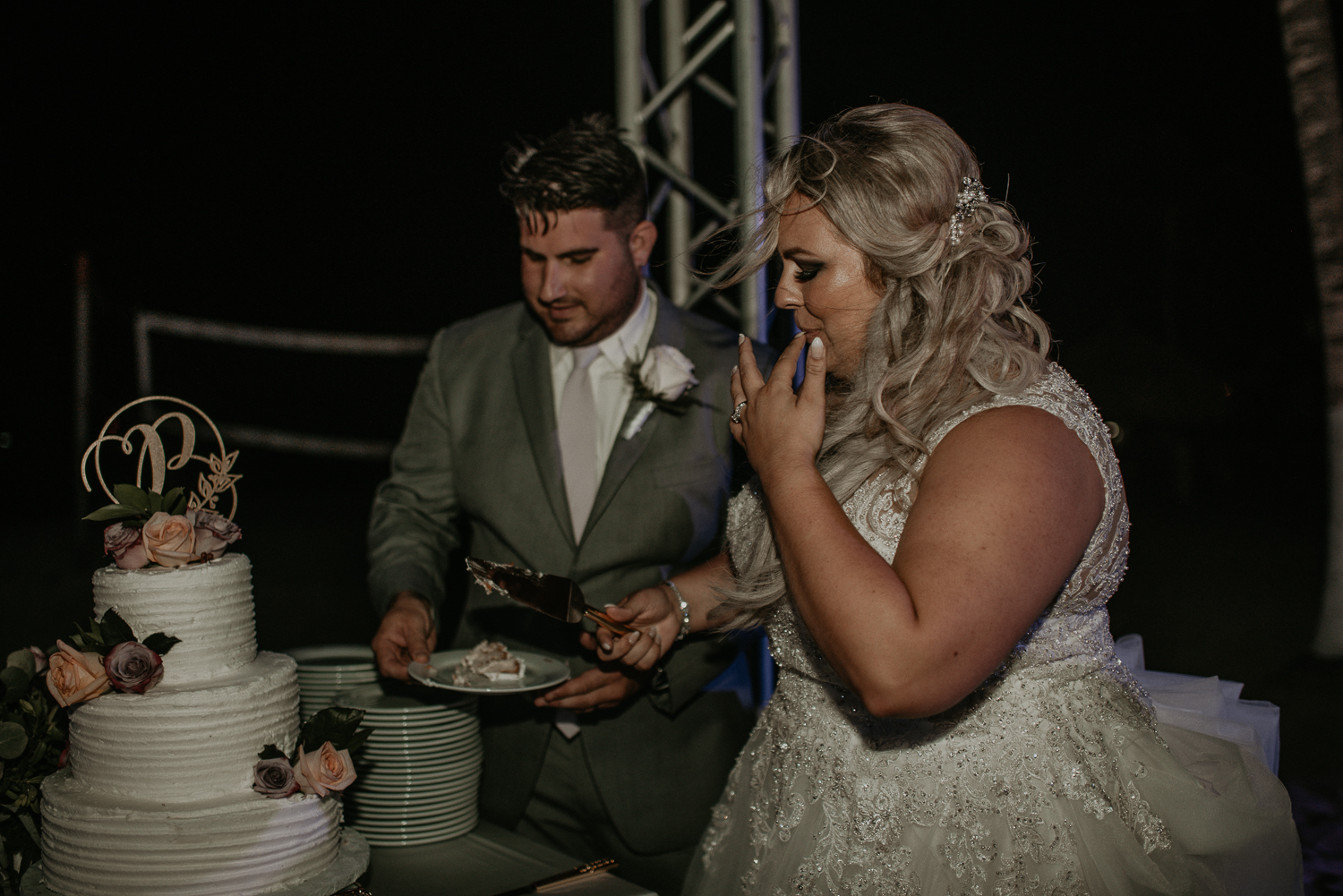 Bride and groom cutting wedding cake