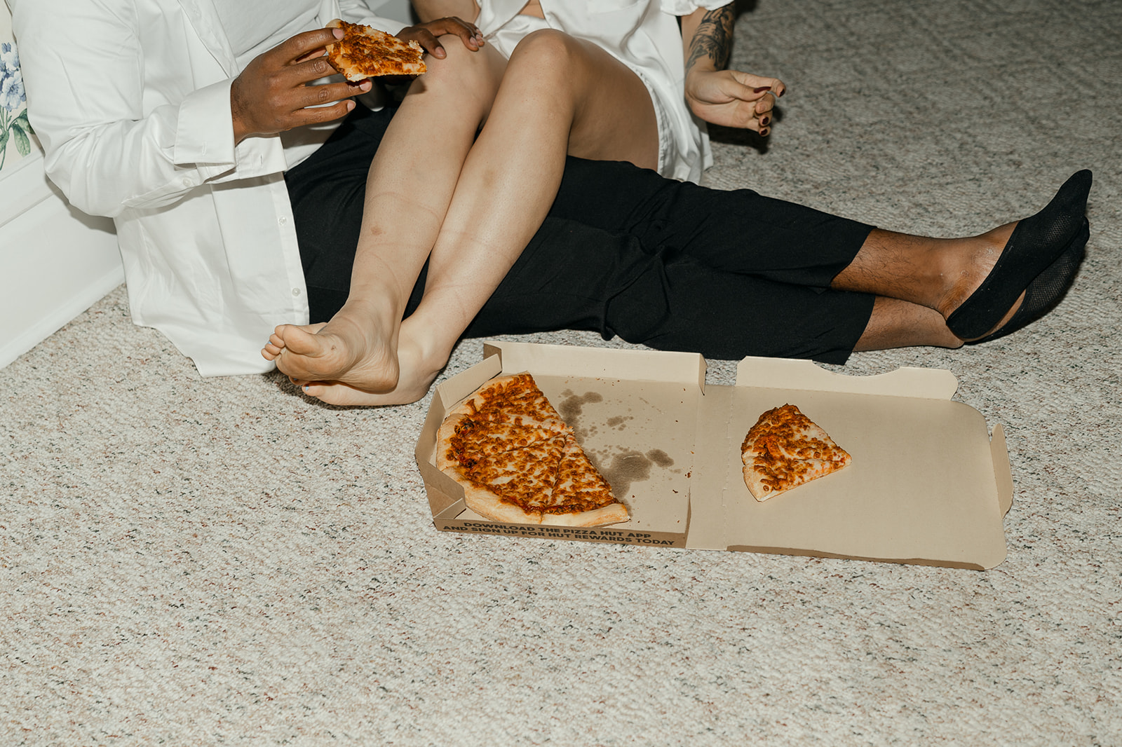 Bride and groom eating pizza after their wedding