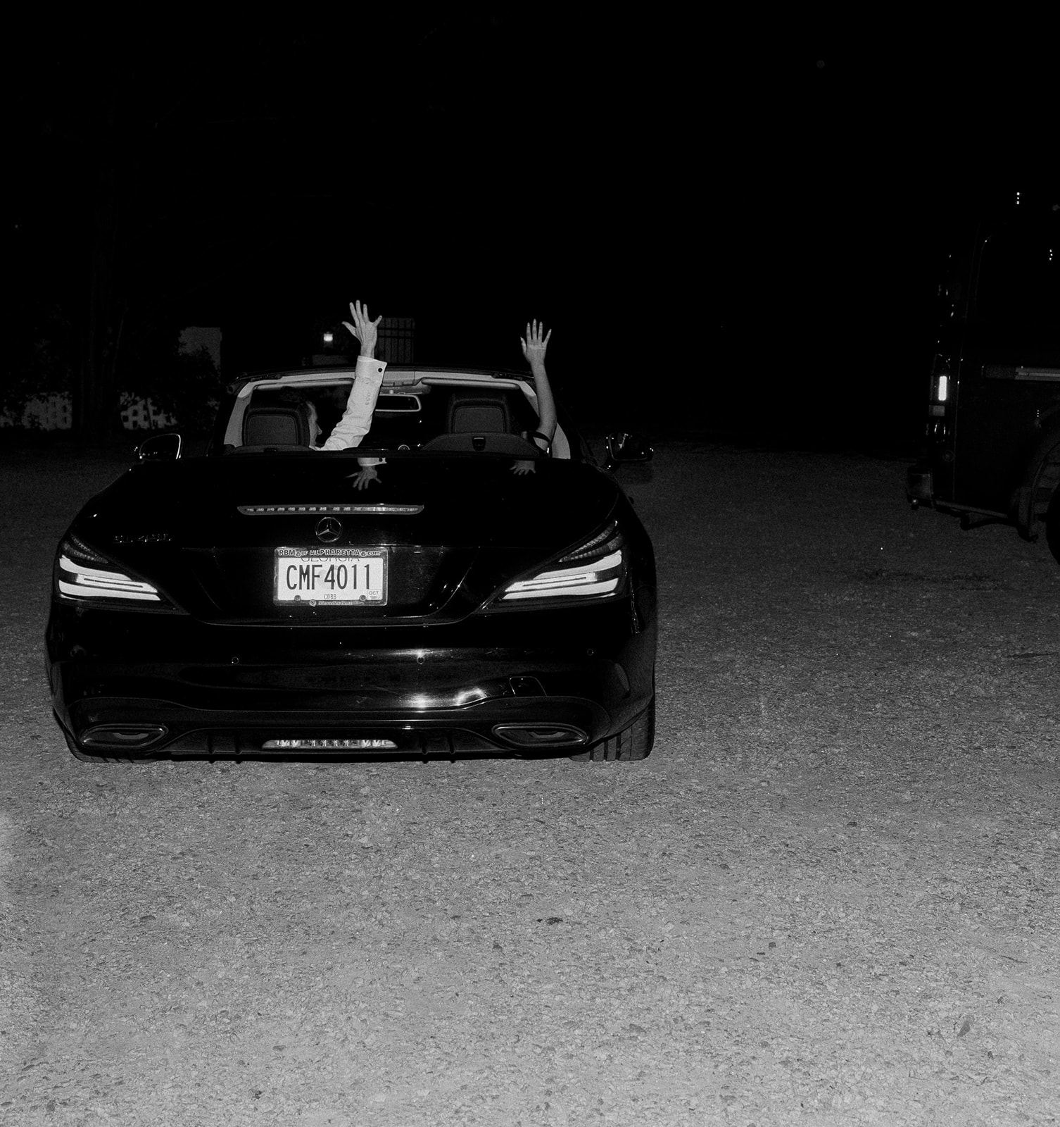 Bride and groom's wedding exit in their convertible 