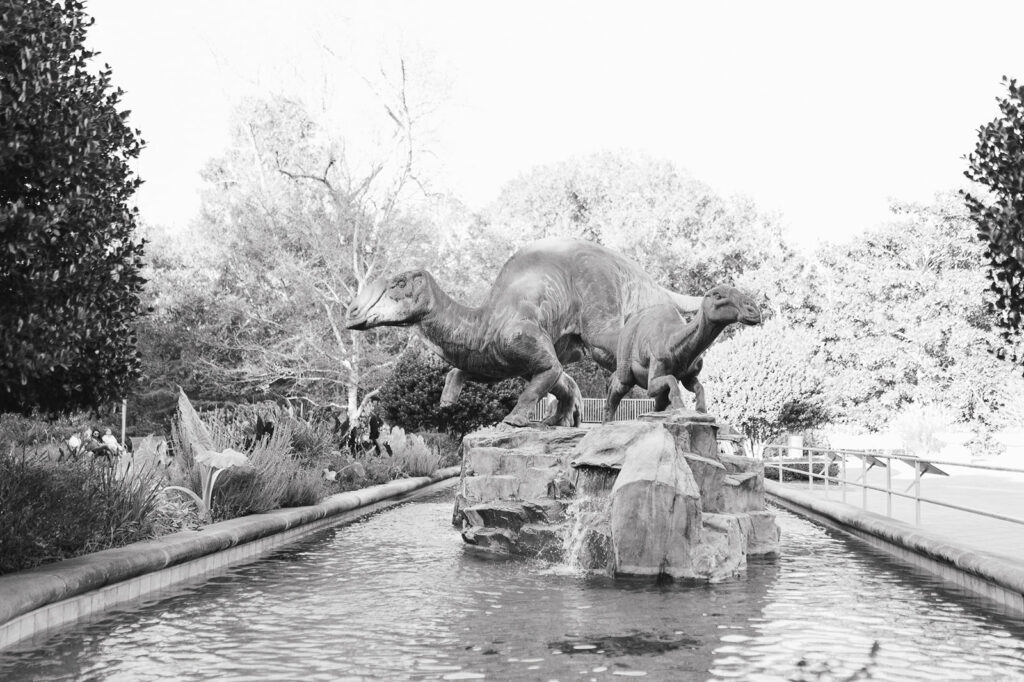 Black and white photo of the dinosaur sculptures at Fernbank Museum in Atlanta, Georgia. 