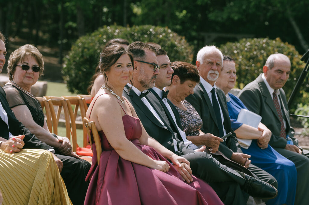 Candid photos of wedding guests during an outdoor wedding ceremony
