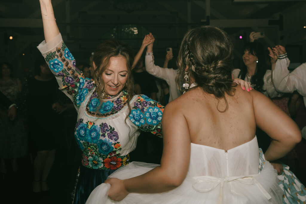 Bride dancing with wedding guest during the reception 