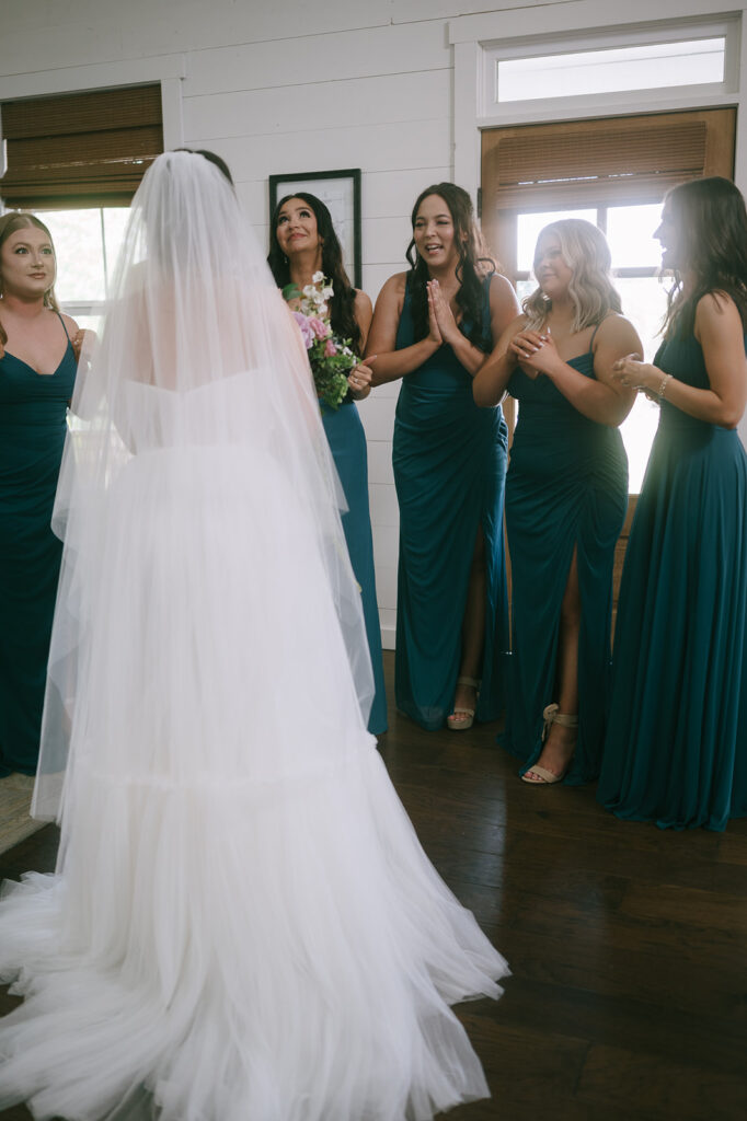 Brides emotional first looks with her bridesmaids