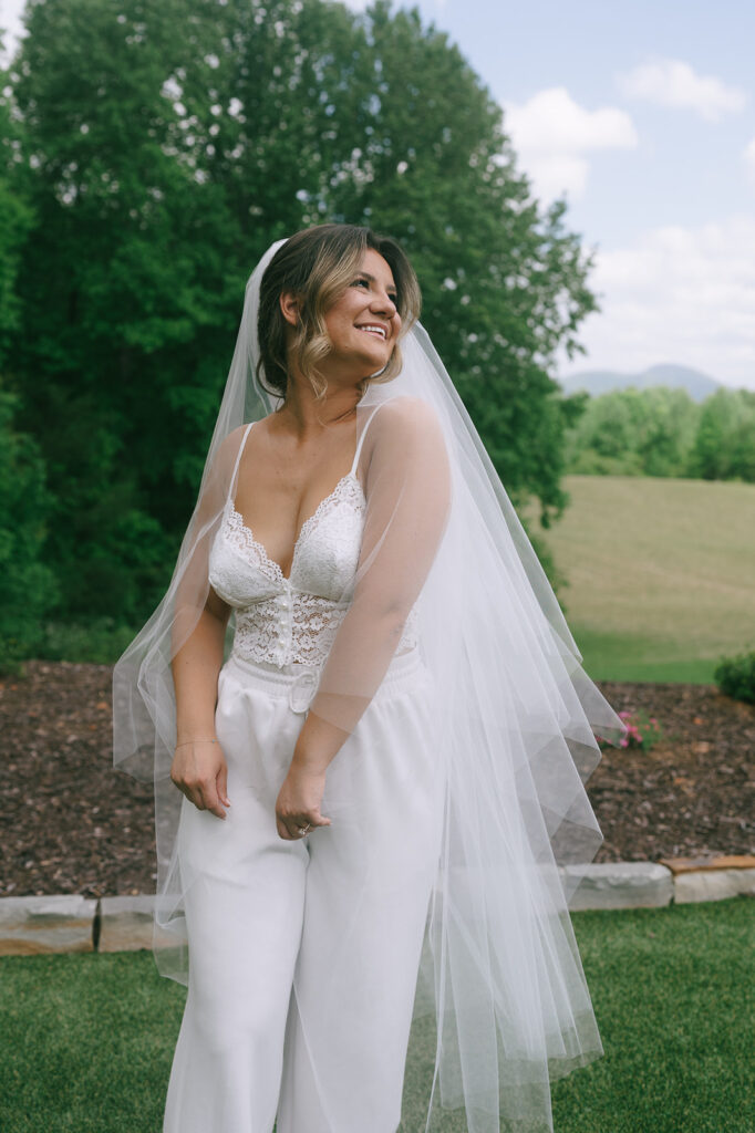 Bride wearing her white pajama set with her veil