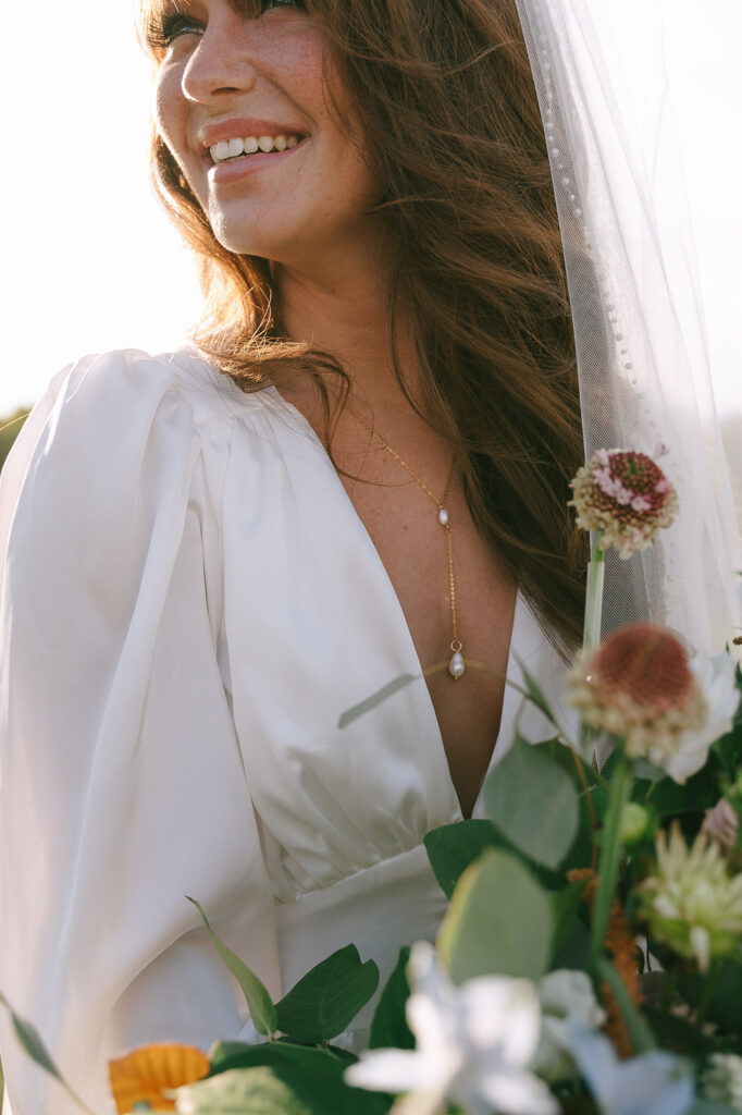 Close up shot of a bride holding her bouquet during sunset.