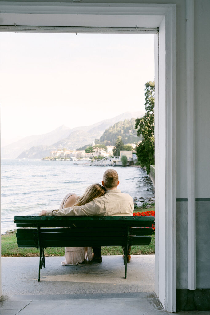 A couple sitting on a bench and enjoying the views of Lake Como, Italy