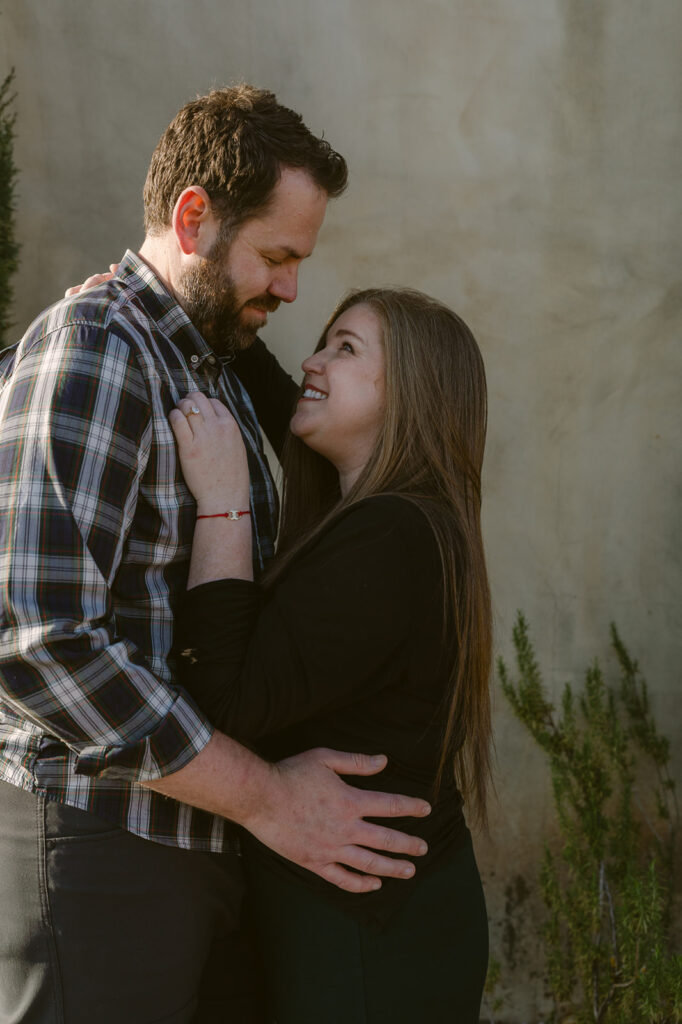 newly engaged couple looking at each other 