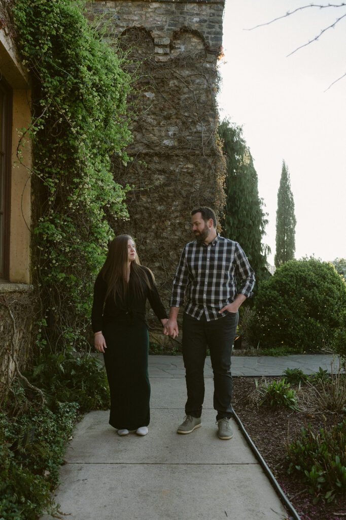 couple holding hands looking at each other 