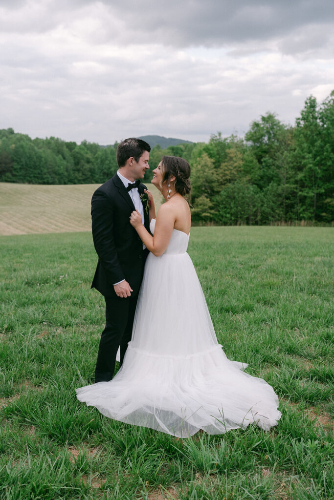 bride and groom smiling at each other 