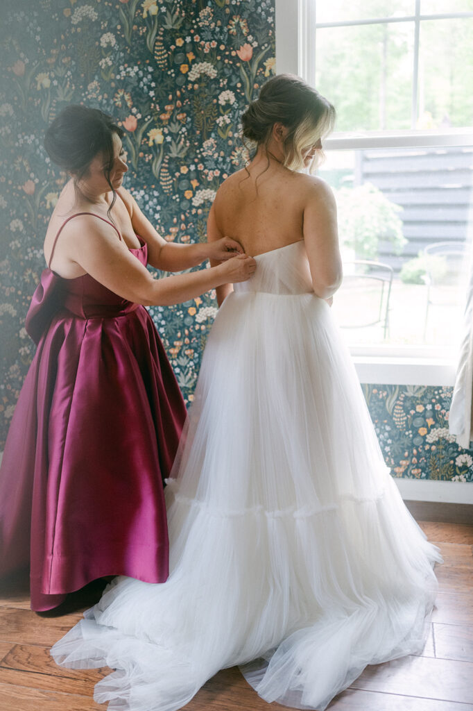 mother of the bride helping the bride get ready for her ethereal wedding ceremony 