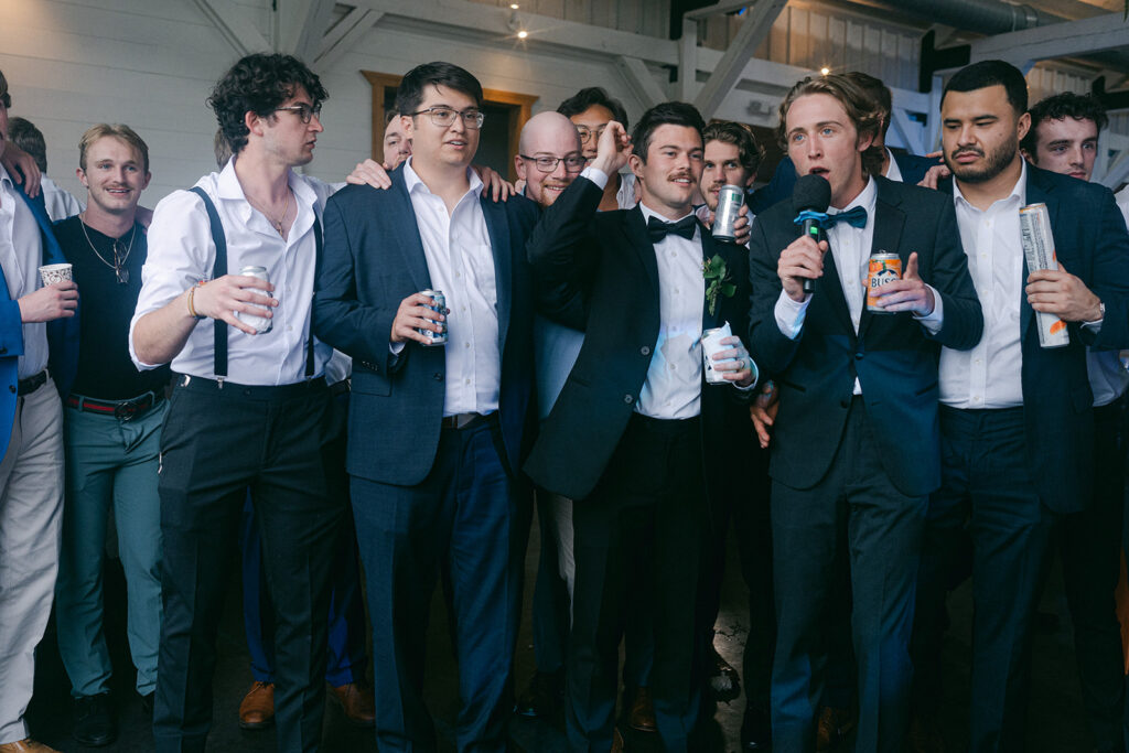 groom and his friends dancing at the wedding reception