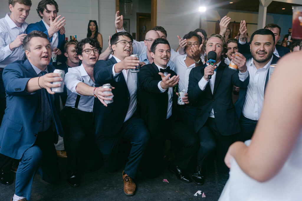 groom and the groomsmen dancing at the wedding party