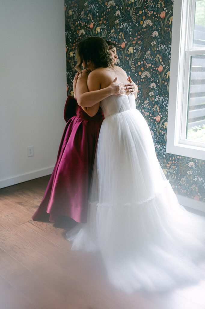 bride and her mom hugging before the wedding ceremony