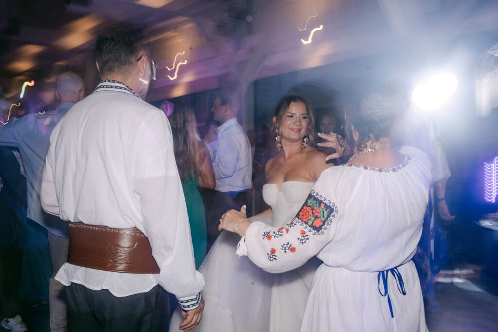 bride and her parents dancing at the wedding recception