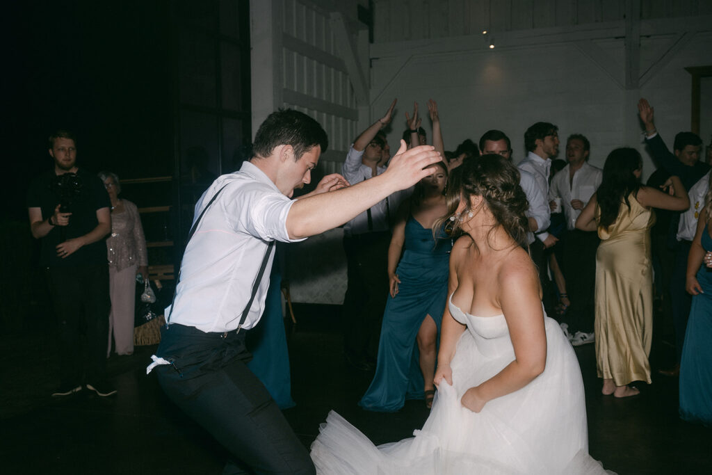 bride and groom dancing at their lively wedding party