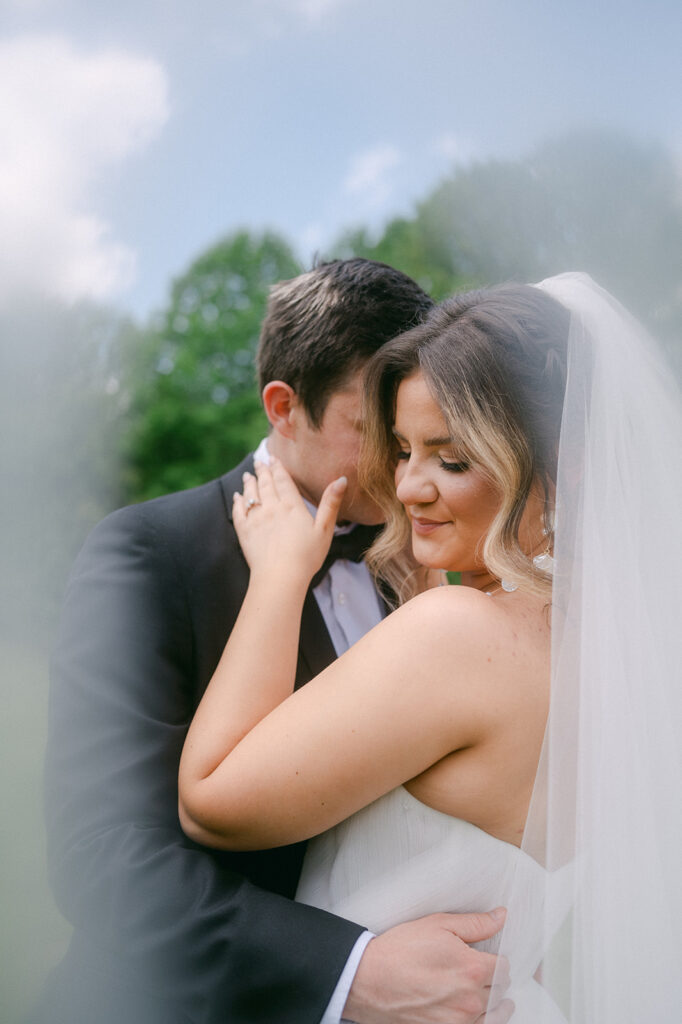 groom kissing the bride on the cheek