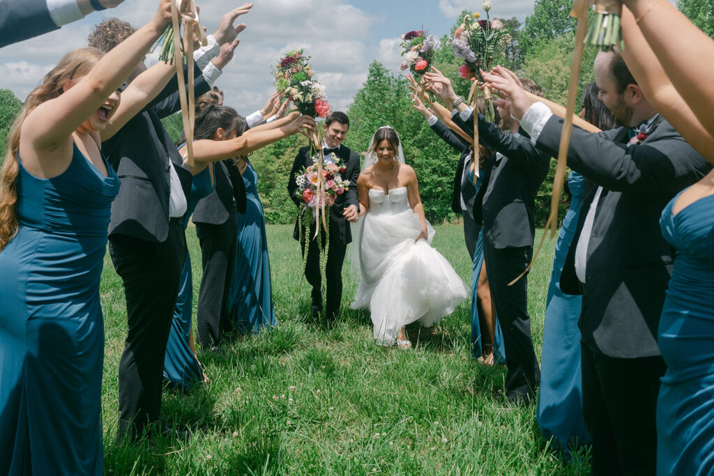 couple holding hands walking around their wedding venue