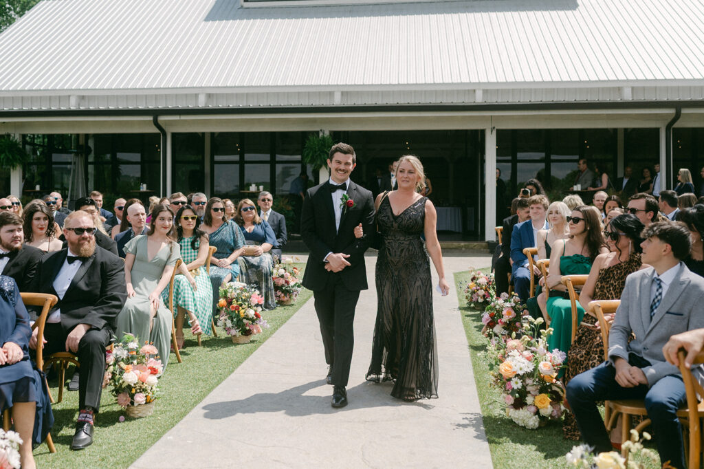 groom walking down the aisle at the ethereal wedding ceremony