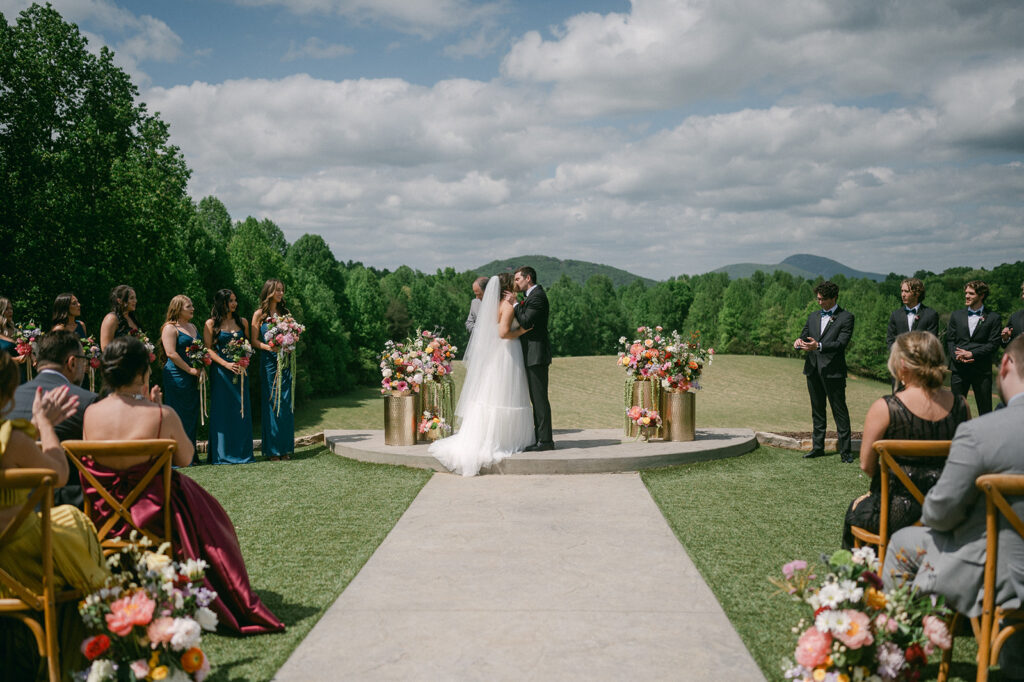 bride and groom kissing after their wedding ceremony 