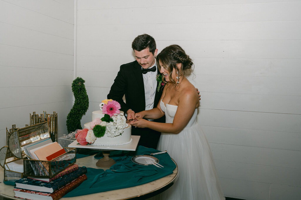 bride and groom cutting their wedding cake