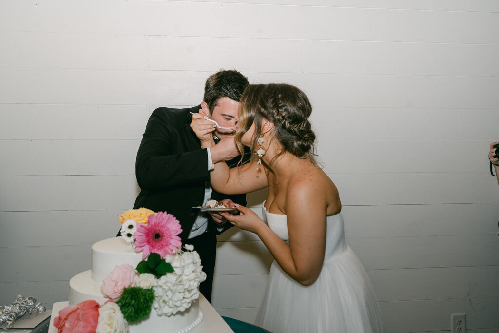 bride and groom trying their wedding cake 