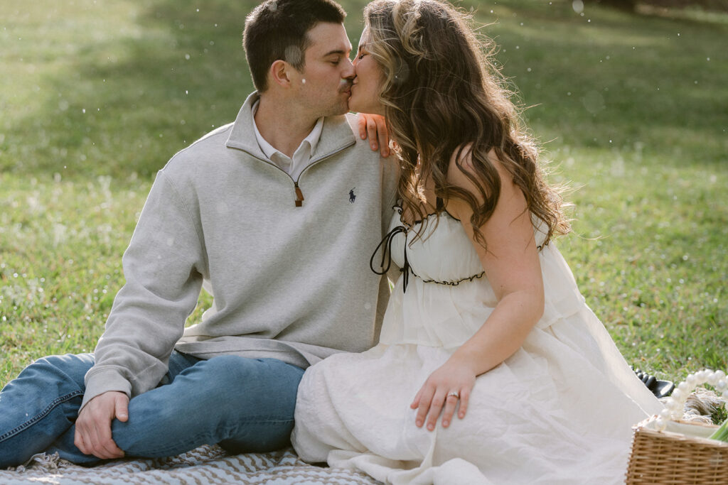 newly engaged couple kissing 