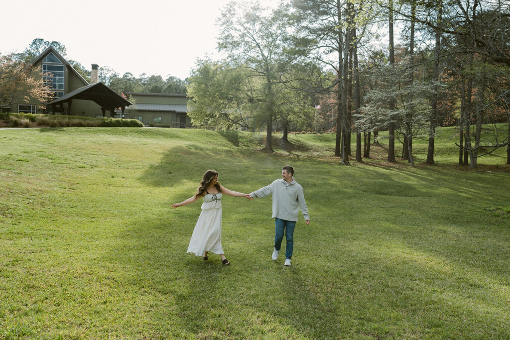 newly engaged couple holding hands