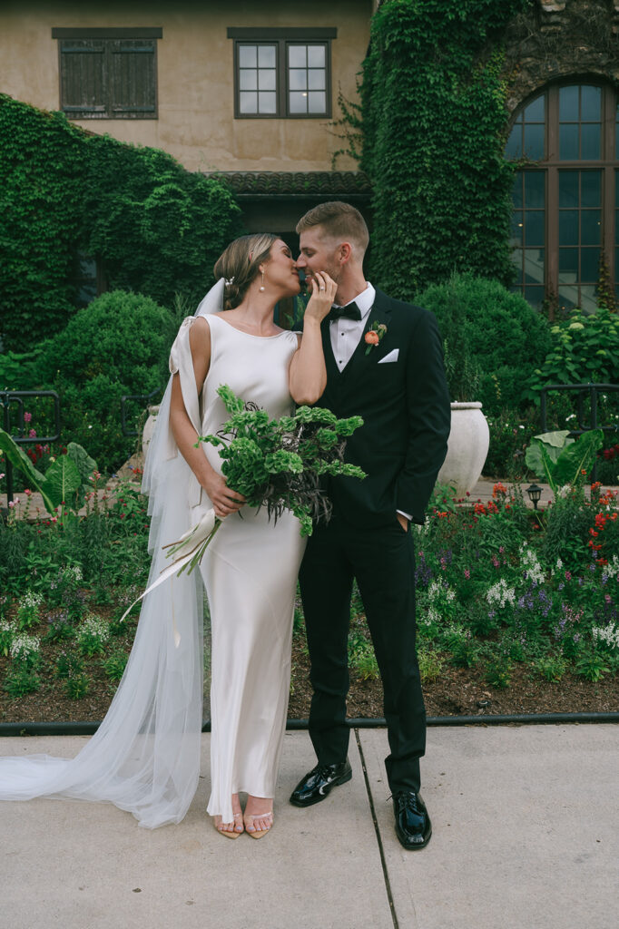 bride and groom kissing after their wedding ceremony 