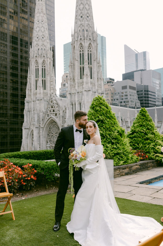 groom kissing the bride on the forehead 